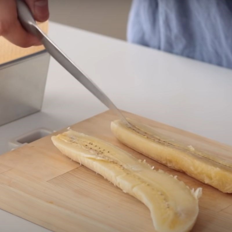 Slicing banana lengthwise for topping