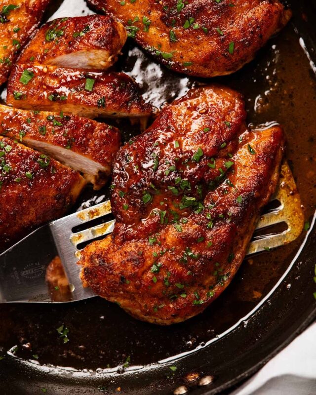 Golden pan-seared chicken breast with parsley garnish