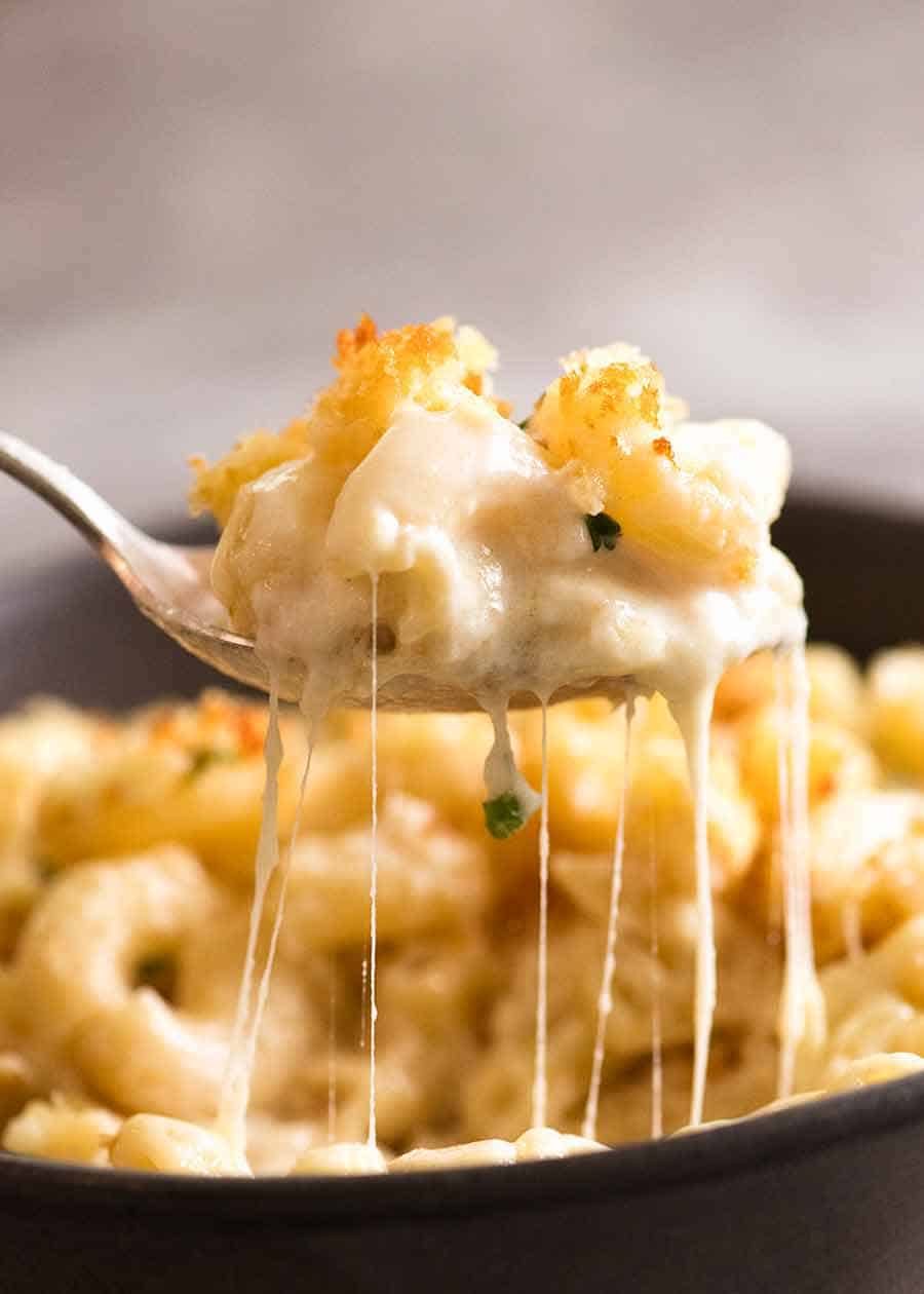 Spoon lifting cheese sauce