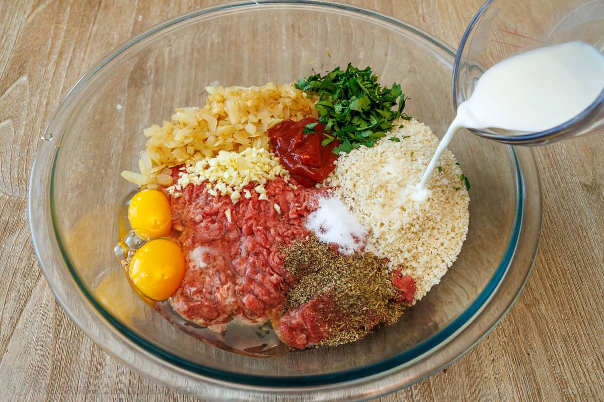 All meatloaf ingredients combined in a mixing bowl