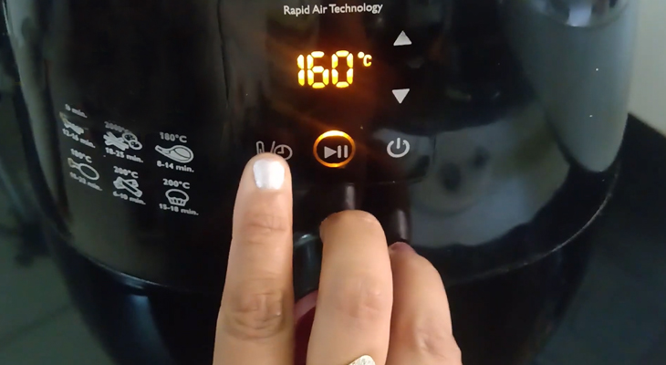 Placing shaped cookie dough into an air fryer basket.