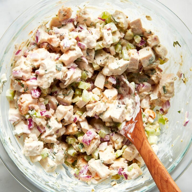 Adding chopped celery and onions to the bowl